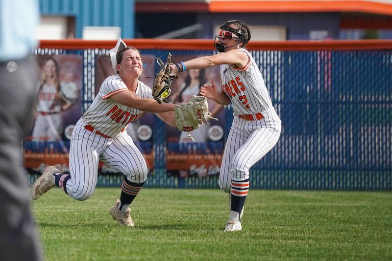 Oswego right fielder Rhiana Martinez, right, catches a fly ball in front of center fielder Savannah Page during a softball game against Yorkville at Oswego High School on Thursday, May 15, 2025.