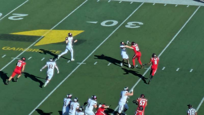 NIU quarterback Josh Holst scrambles before finding an open receiver in the Huskies game at Ball State on Saturday, Oct. 26, 2024.