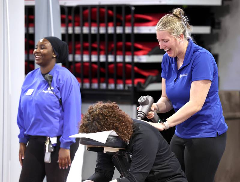Maddie Ford, a case manager and marketing assistant at Sycamore Integrated Health, gives a free massage at their booth Thursday, April 24, 2025, during the Local Showcase and Spring Show in the Convocation Center at Northern Illinois University in DeKalb.