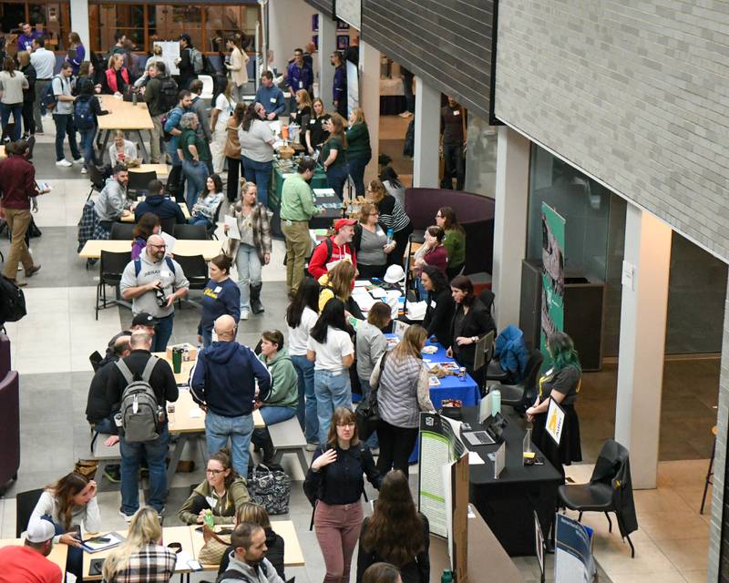 Attendees of The Climate of Hope Conference 2024, talk with venders during a break on Friday March 1, 2024, held at Downers Grove North High School.