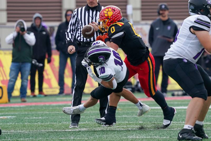 Batavia's RJ Bohr (0) hits Downers Grove North's Oliver Thulin (10) during a class 7A quarterfinal playoff football game at Batavia High School on Saturday, Nov. 16, 2024.