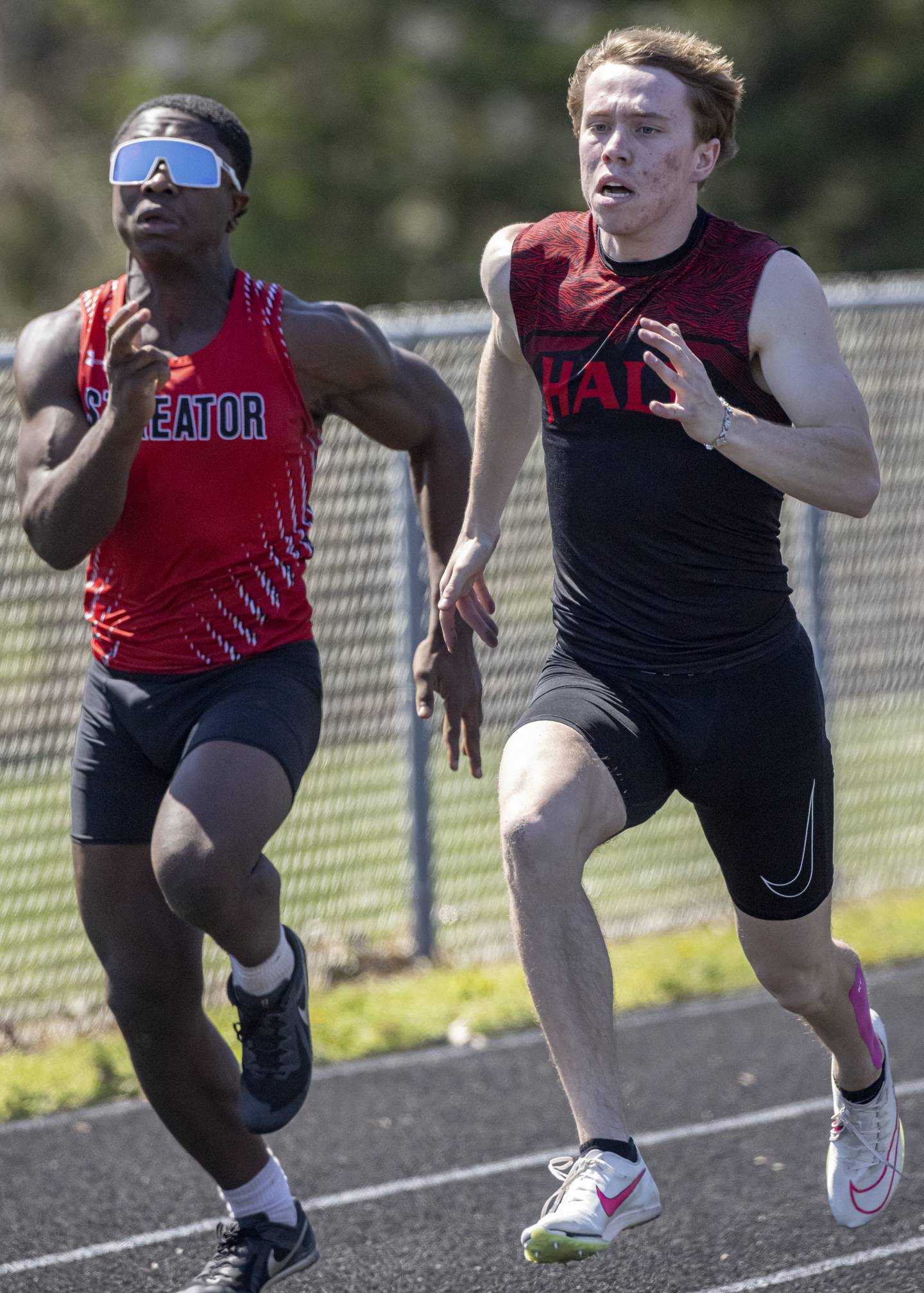 Caleb Bickett (Hall) battles it out with Jordan Lukes (Streator) in the men's 100 meter sprint during the Rollie Morris Invite at Hall High School on April 13, 2024. They both posted an 11.1 second time with Brown just edging out Bickett for the win.