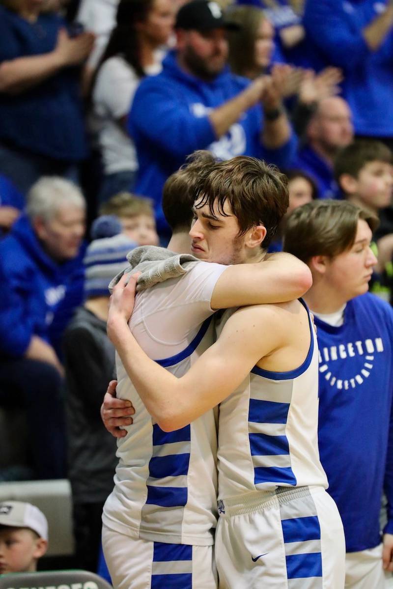 Princeton senior Grady Thompson (right) embraces junior teammate Korte Lawson after checking out of Friday's Class 2A Orion Sectional at Geneseo. The Tigers saw their season end with a 64-46 loss to Rockridge
