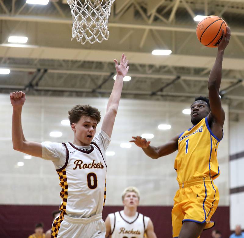 Johnsburg's Jarrel Albea (right) drives to the basket against Richmond-Burton's Gavin Radmer during a Kishwaukee River Conference boys basketball game on Tuesday, Jan. 27, 2026, at Richmond-Burton High School.