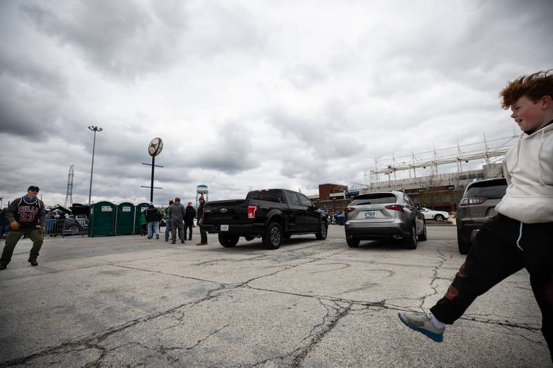 Patrick Smith, left, and his son Caleb, kick around a rugby ball as the tailgate outside Seat Geek Stadium before a Chicago Hounds rugby game in Bridgeview, on Sunday April 23, 2023.