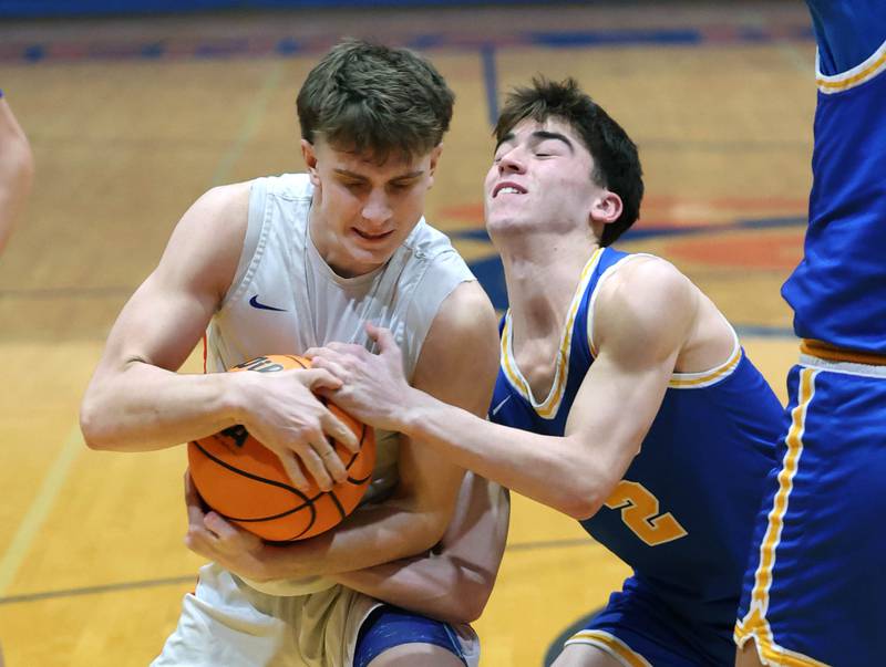 Genoa-Kingston's Jaiden Lee (left) and Aurora Central Catholic's Ben Bohr get tied up Monday, Feb. 23, 2026, during their IHSA Class 2A regional quarterfinal at Genoa-Kingston High School.