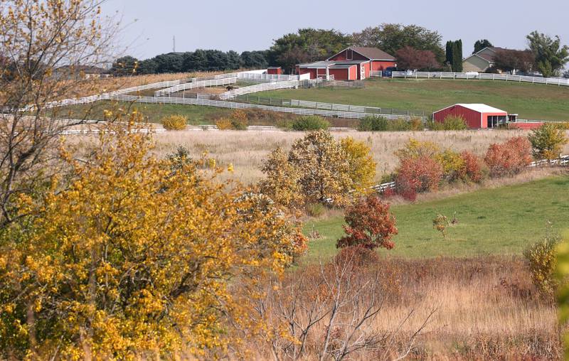 A farm surrounded by colorful trees Tuesday, Oct. 24, 2023, near Merritt Prairie Forest Preserve just south of DeKalb.