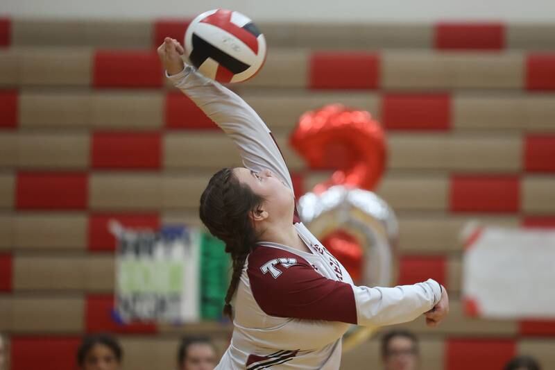 Plainfield North’s Madeline Haubert serves against Plainfield East on Thursday night.