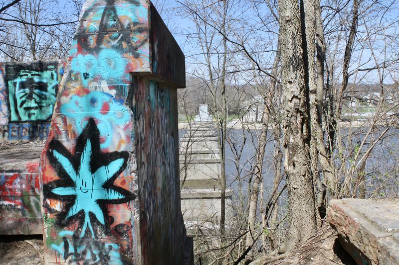 At the north end of the remnant of the former Illinois Central Railroad line, concrete bridge pylons can be seen jutting up from their base in the Rock River in Dixon on Tuesday, April 11, 2023.  Dixon was awarded a $2.25 million state grant for a bike path extension through the Illinois Transportation Enhancement Program.