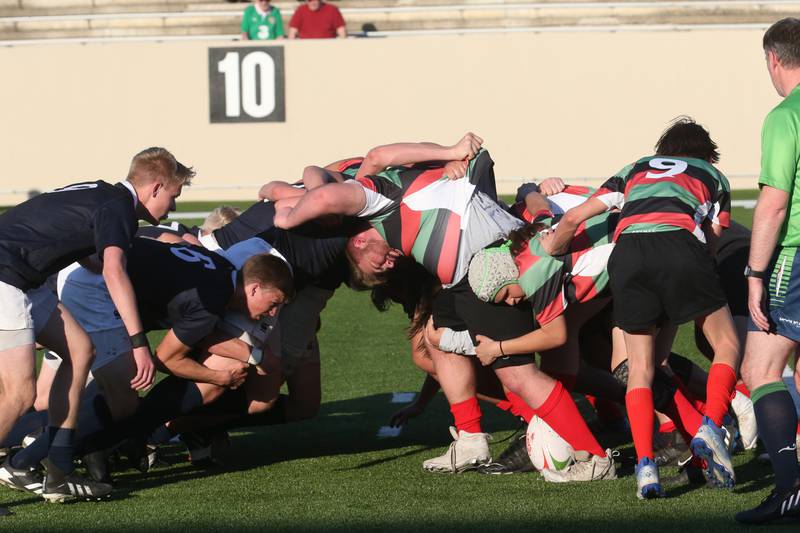 La Salle-Peru and La Salette Academy rugby teams battle during a scrum during a rugby game on Wednesday, April 12, 2023 at Howard Fellows Stadium at L-P High School. A Scrum or scrummage, is a method of restarting play in rugby football that involves players packing closely together to gain possession of the ball.