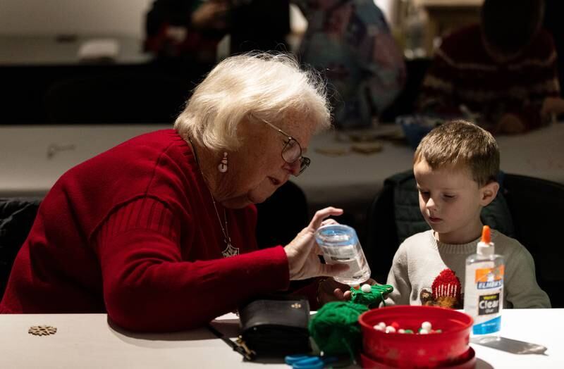Mary Brennan, left, helps her grandson Rowan Binenfeld, 4, make a Christmas tree ornament during a Merry & Bright Victorian Christmas at the Downers Grove Museum on Saturday, Dec. 14, 2024.