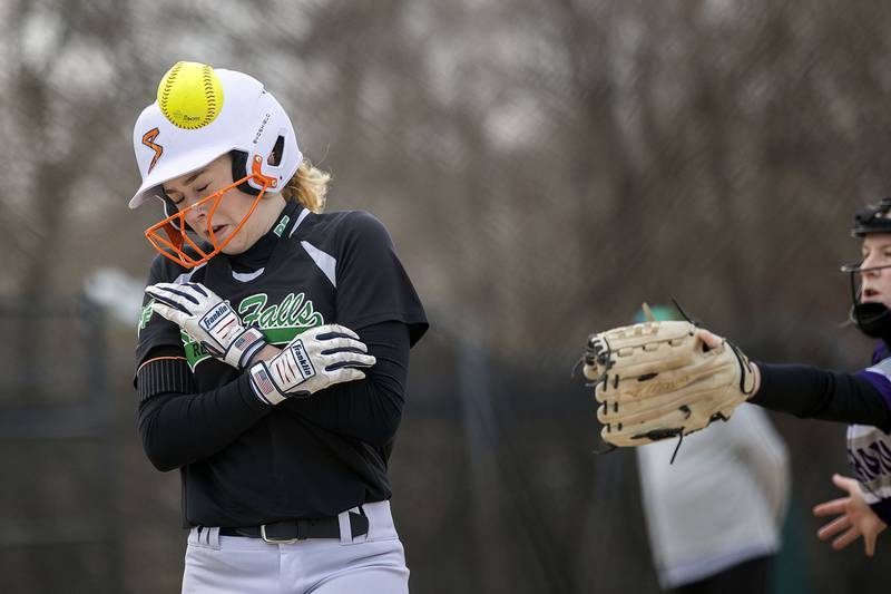Rock Falls’ Zoey Silva is hit by a ball while stealing home against Rockford Lutheran Thursday, April 10, 2025.