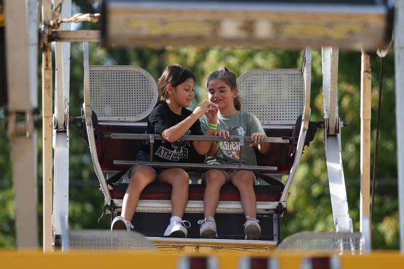 Catalina, left, and Ellie enjoy the Ferris Wheel at the Saint Dennis and Joseph Catholic Academy Annual Oktoberfest on Saturday, Oct. 5, 2024 in Lockport.