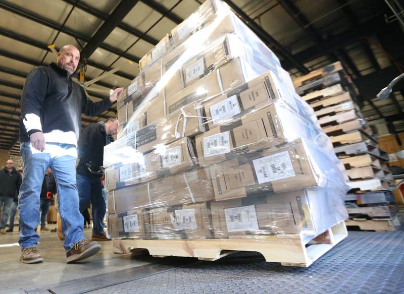 Kevin Dale of Labors 393 helps push a pallet load of bicycles onto a semi truck in the loading dock area at DD Warehouse on Thursday, Dec. 1, 2022 in Peru.