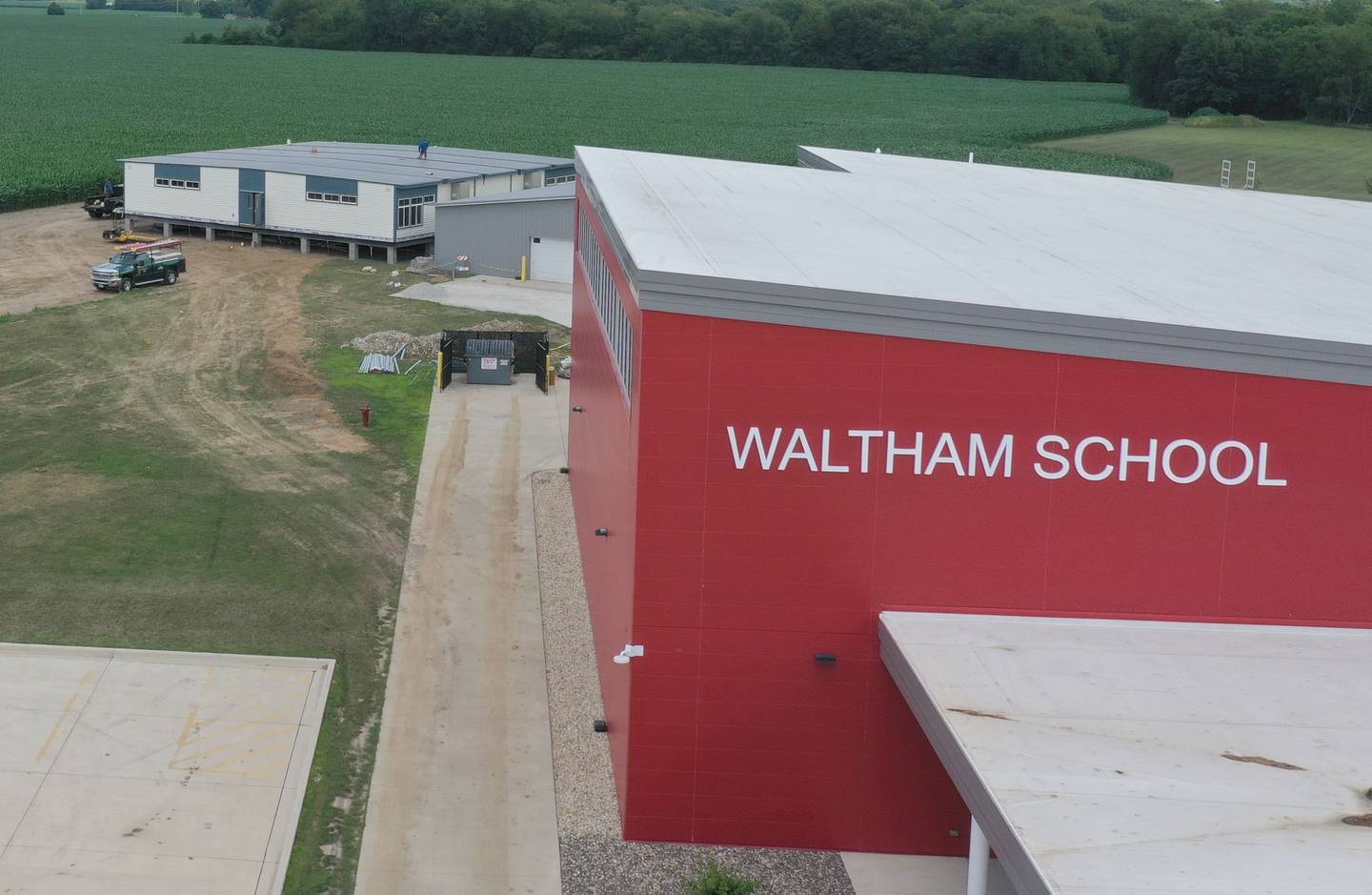 Crews install four 70 x 70 modular classrooms on the new property next to Waltham School on Monday, July 8, 2024 in Utica. The school, built in 2018, has already outgrown its 240 student capacity and placed the four classrooms next to the school.