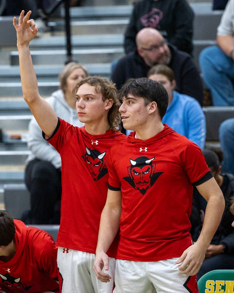 Hall players hold up 3 fingers as teammate shoots 3-pointer in the Shipyard Showdown on Tuesday, December 23, 2025 at Seneca High School in Seneca.
