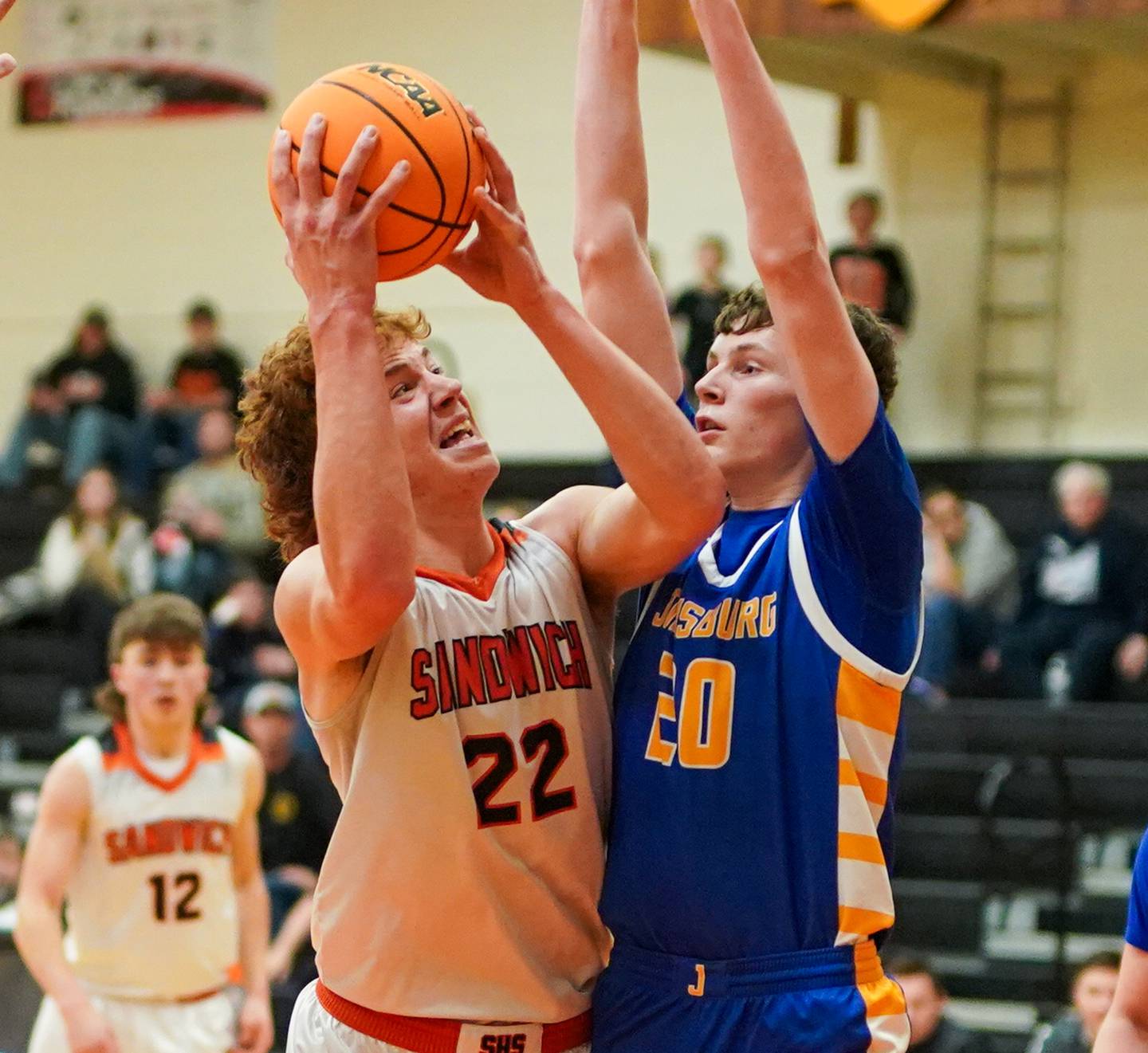 Sandwich’s Dom Rome (22) shoots the ball in the post against Johnsburg's Joshua Kaunas (20) in a game this past season at Sandwich High School.
