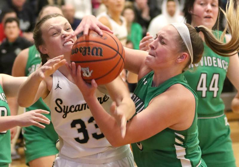 Sycamore's Ella Shipley and Providence Catholic's Annalise Pietrzyk fight for possession during their game Tuesday, Feb. 22, 2022, in the Class 3A Kaneland sectional in Maple Park.