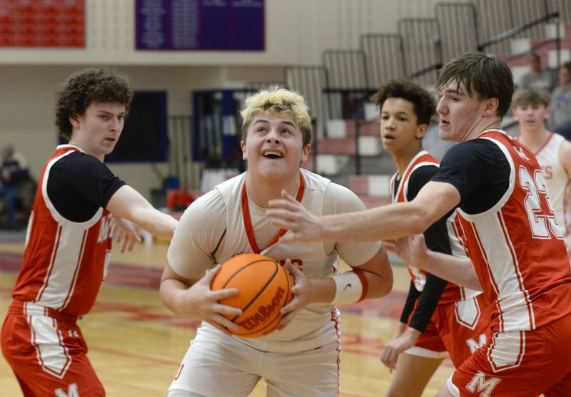 Oregon's Kade Girton (34) prepares to shoot as Morrison's Brayden Rubright (left) and Asher Ernst (right) defend on Saturday, Jan. 11, 2025 at the Blackhawk Center in Oregon.