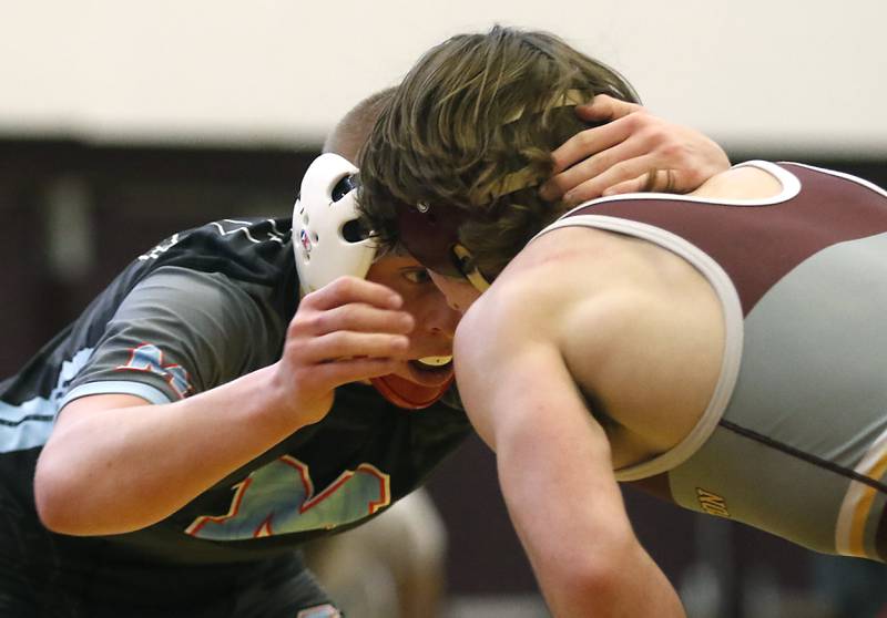 Marian Central’s Charlie Fitzgerald keeps his eye on Richmond-Burton’s Brody Rudkin as they compete in the 145-pound championship wrestling match in the IHSA 1A Richmond-Burton Wrestling Regional Thursday, Jan. 19, 2023, at Richmond-Burton High School in Richmond.