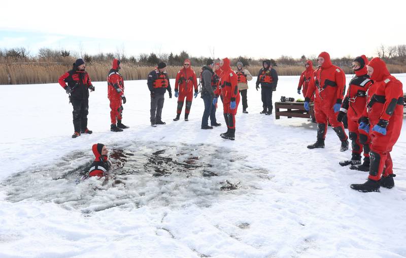 Utica, Oglesby and Tonica firefighters conduct an ice-rescue training drill as Utica fire chief Ben Brown gets into a ice hole while using an inflatable ice raft on a private pond on Sunday, Feb. 1, 2026 south of Utica.