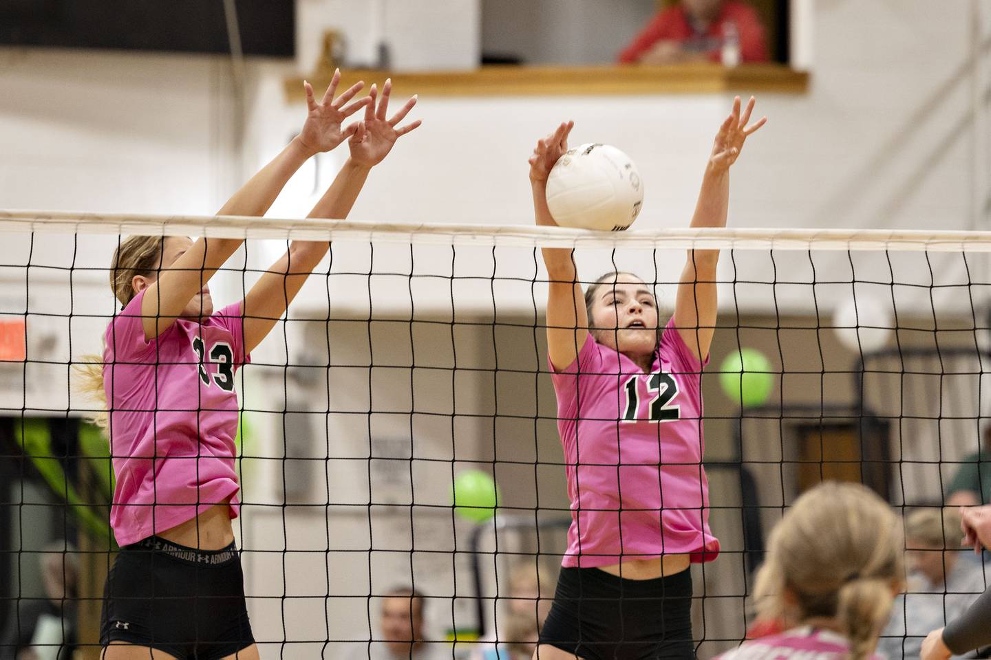 Dixon’s Ella Govig (left) and Joey Brumbly go up to block a shot Thursday, Oct. 13, 2022 against Rock Falls.