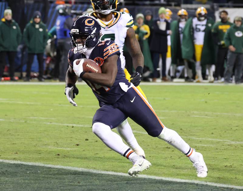 Chicago Bears wide receiver Olamide Zaccheaus scores a touchdown in front of Green Bay Packers linebacker Quay Walker during their NFL Wild Card game Saturday, Jan. 10, 2026, at Soldier Field in Chicago.