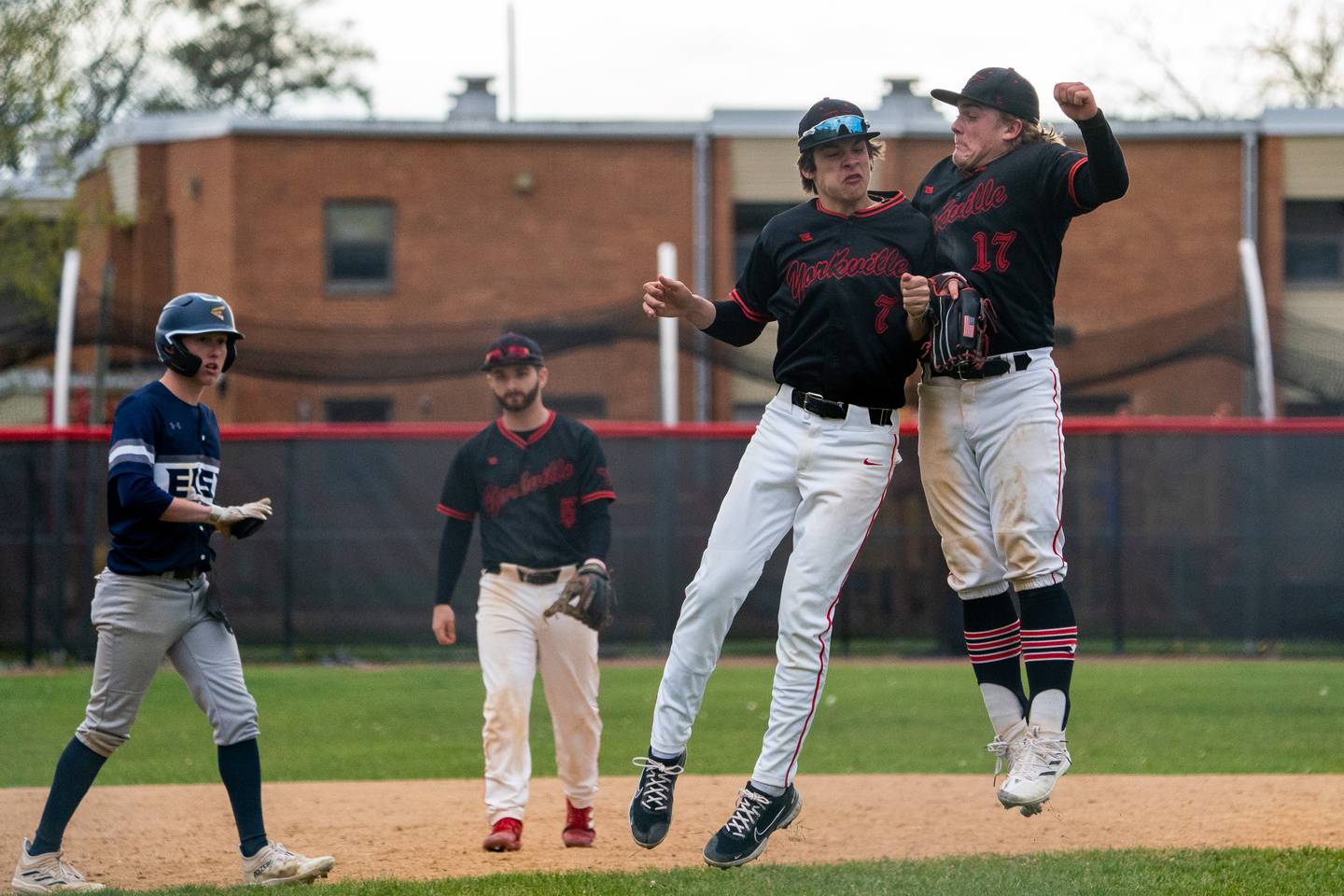 Yorkville's Jackson Roberts (7) and Kam Yearsley (17) celebrate after defeating Oswego East at Yorkville High School on Tuesday, May 2, 2023.