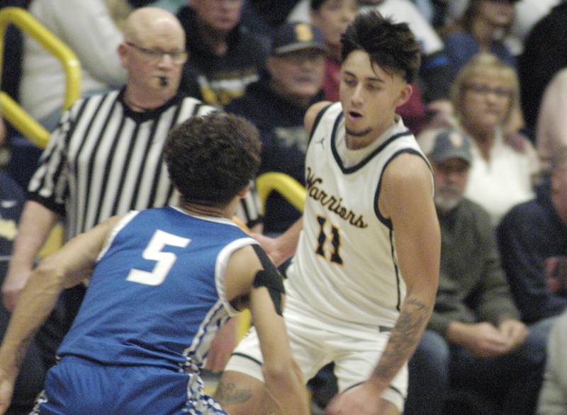 Sterling's Nico Battaglia brings ball  through Quincy defender Kameron Wires. The action took place on Friday, December 13th at Sterling.