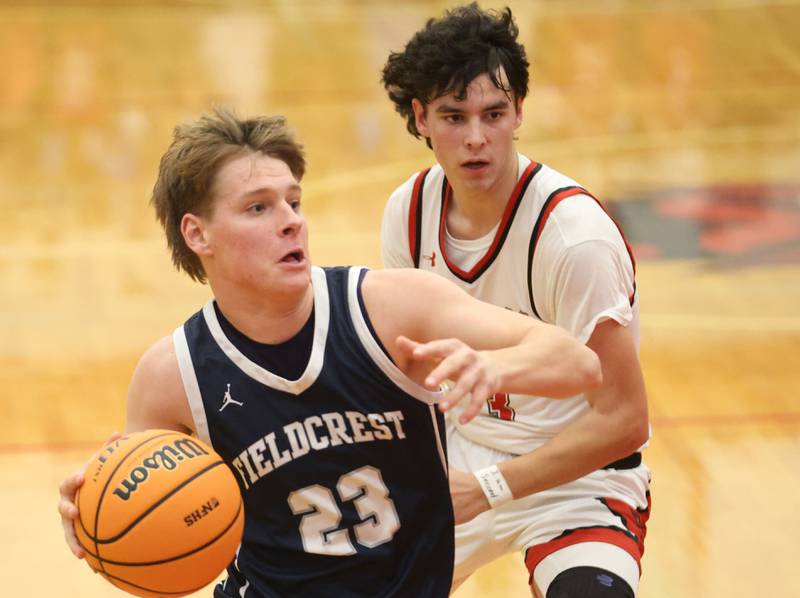 Fieldcrest's Eli Gerdes runs past Hall's Noah Plym during the Colmone Classic on Friday, Dec. 12, 2025 at Hall High School.