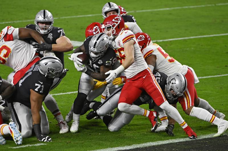 Las Vegas Raiders running back Josh Jacobs (28) scores a touchdown against Kansas City Chiefs linebacker Ben Niemann (56) during the first half of an NFL football game, Sunday, Nov. 22, 2020, in Las Vegas. (AP Photo/David Becker)