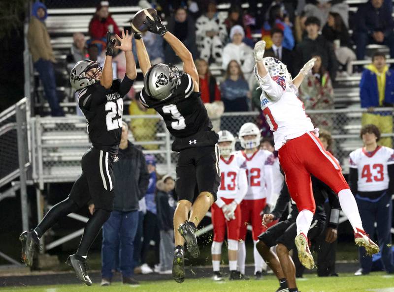 A pass intended for Lakes’ Brett Beerbrower is intercepted by Kaneland's Luke Gadomski in front of teammate Isaac Taylor Saturday, Nov. 1, 2025, during their first round playoff game at Kaneland High School in Maple Park.