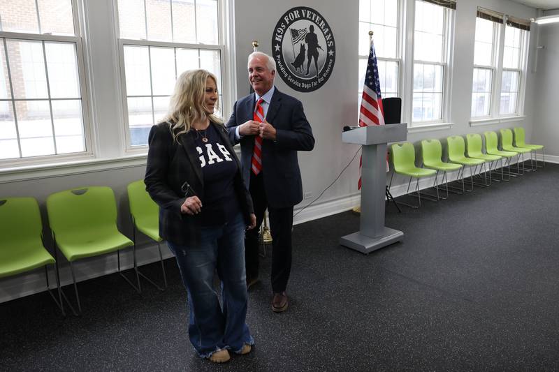 Gina Glasgow (left) and Terry D’Arcy, a Joliet mayoral candidate, talk before the start of a K9s for Veterans ribbon-cutting ceremony at its new training campus on Wednesday, Feb. 15, 2023, in Joliet.