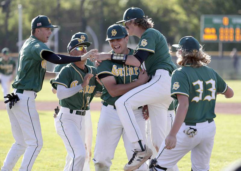 Crystal Lake South's Ysen Useni, center, is mobbed by teammates after defeating Grayslake Central during the IHSA Class 3A sectional semifinals, Thursday, June 2, 2022 in Grayslake.