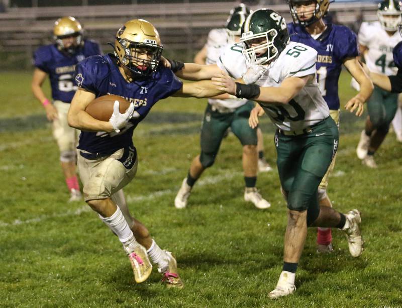 Marquette Payton Gutierrez stiff arms St. Bede's Jake Miglorini on Friday, Oct. 13, 2023 at Gould Stadium.