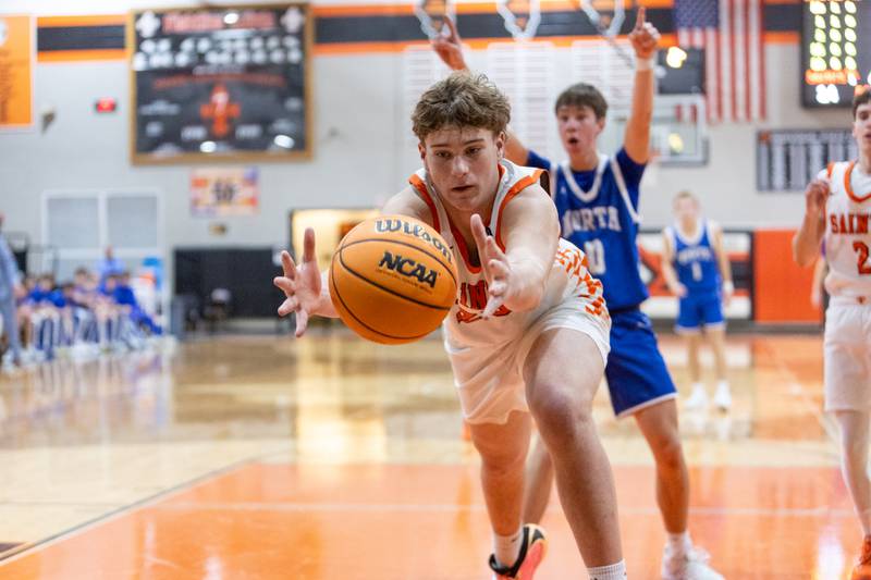 St. Charles East's Liam Barrett goes for the lose ball against Wheaton North on Saturday, Dec.13,2025 in St. Charles.