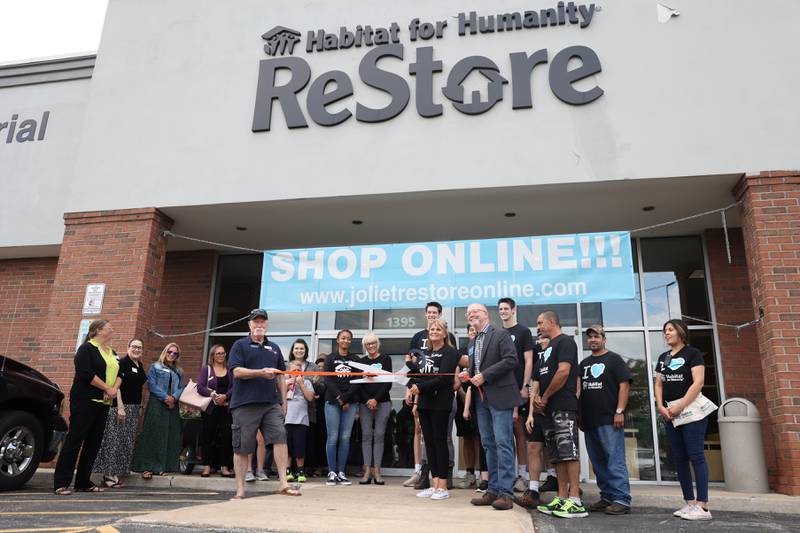 Habitat for Humanity ReStore staff and other members of the community pose for a photo at a ribbon cutting ceremony to commemorate the store's 5th year anniversary on Thursday, July 13th, 2023 in Joliet.