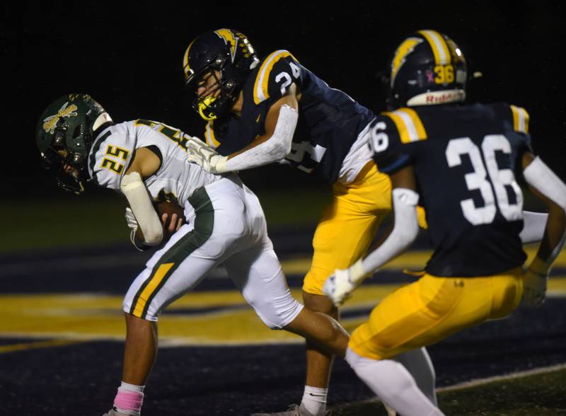Glenbrook North's Rocco Marquez, left, carries the ball into the end zone for a touchdown ahead of Glenbrook South’s Tommy MacPherson during Friday’s game in Glenview.