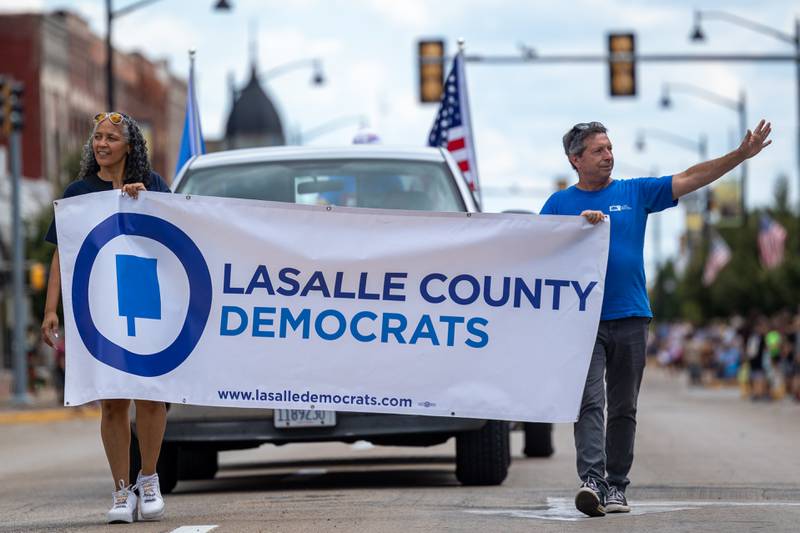 (from left) Gina Harris and Rick Wilkin greet parade goers on Sunday, Aug 31, 2025 at the Labor Day parade on Main Street in Streator.