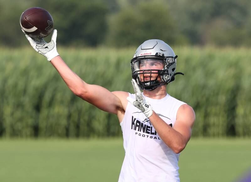 Kaneland’s Ryan Majerus throws the ball back to teammates after making a catch Tuesday, July 16, 2024, during the Kaneland 7-on-7 at the school in Maple Park.
