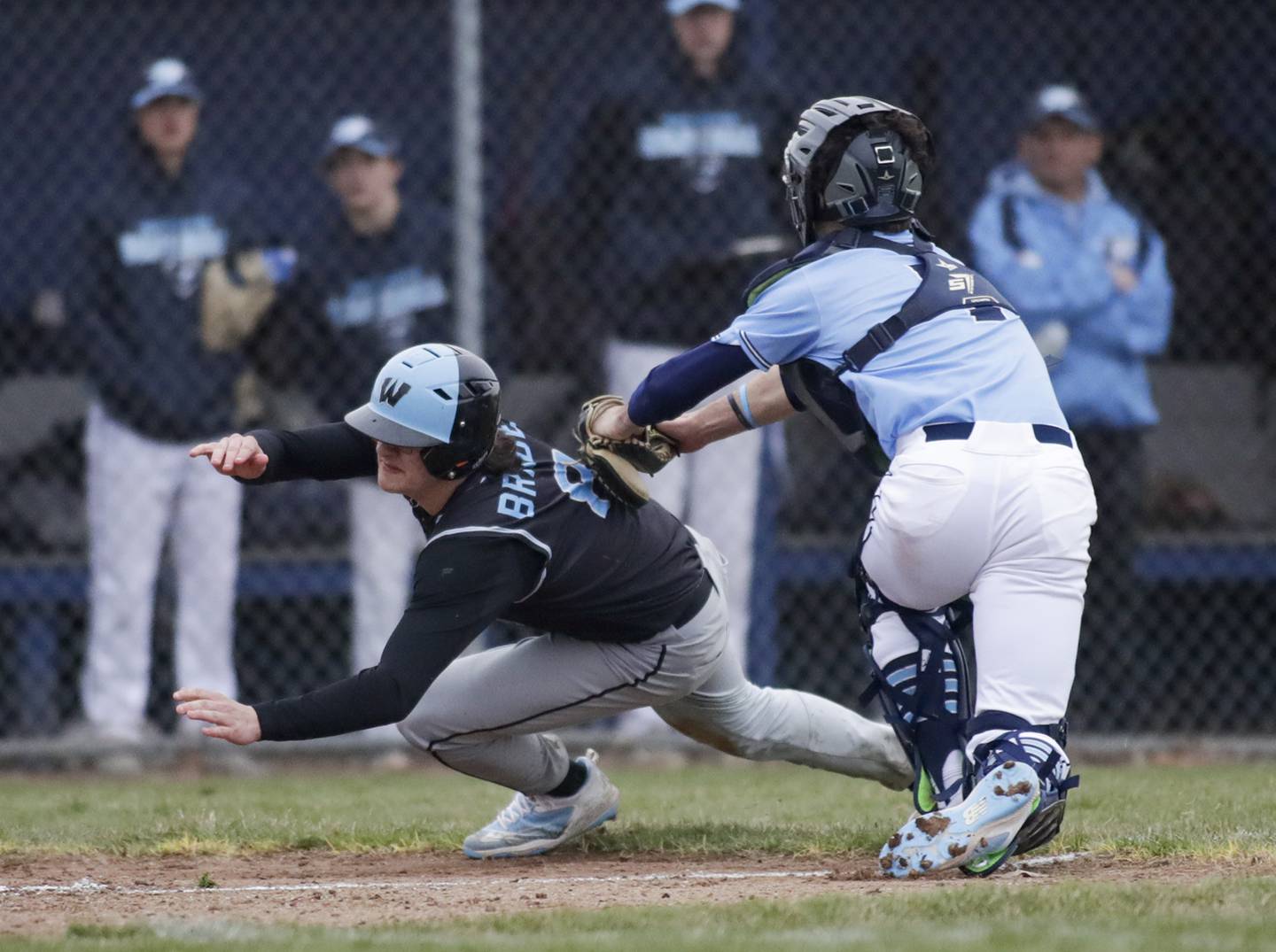 Downers Grove South’s John Szalko (7) tags out Willowbrook’s Joe Braden (8) at home plate during a game in Downers Grove on Tuesday, April 5, 2022.