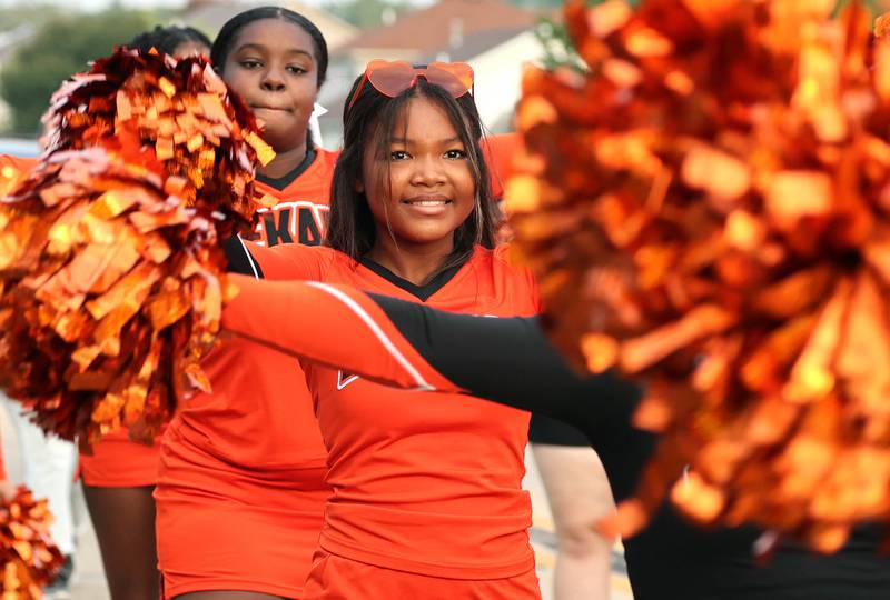 DeKalb High School cheerleaders march down Dresser Road Wednesday, Sept. 27, 2023, during the homecoming parade.