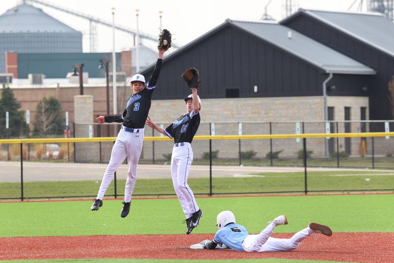 Peotone's Lincoln Tierney (3) leaps to catch a throw to second as teammate Devon Stone backs him up with Kankakee's Bryce Deany sliding in for a steal during their game on Friday, April 3, 2026.