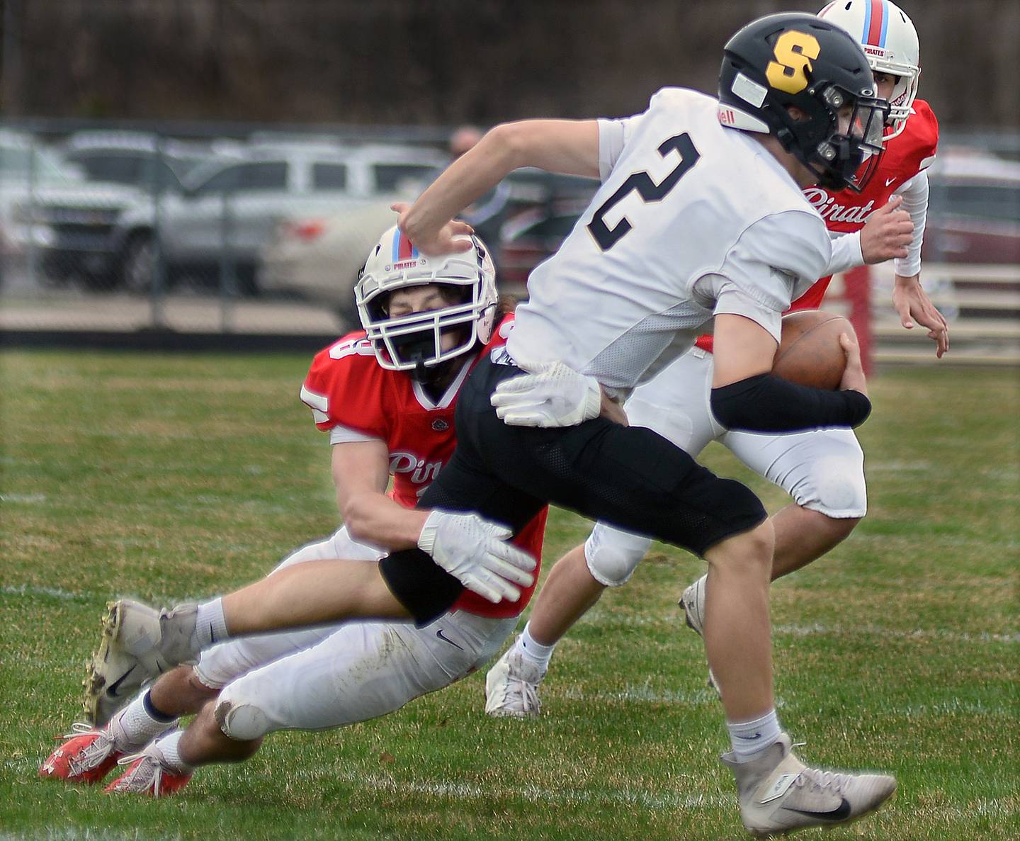 Ottawa's Luke Poffenbarger, tries to bring down Sycamore's Eli Meier on a run in the first quarter Saturday at Ottawa.