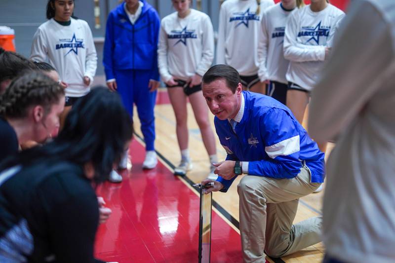 St. Charles North's head coach Mike Tomczak talks to his players during a basketball game against Batavia at Batavia High School on Tuesday, Dec 5, 2023.