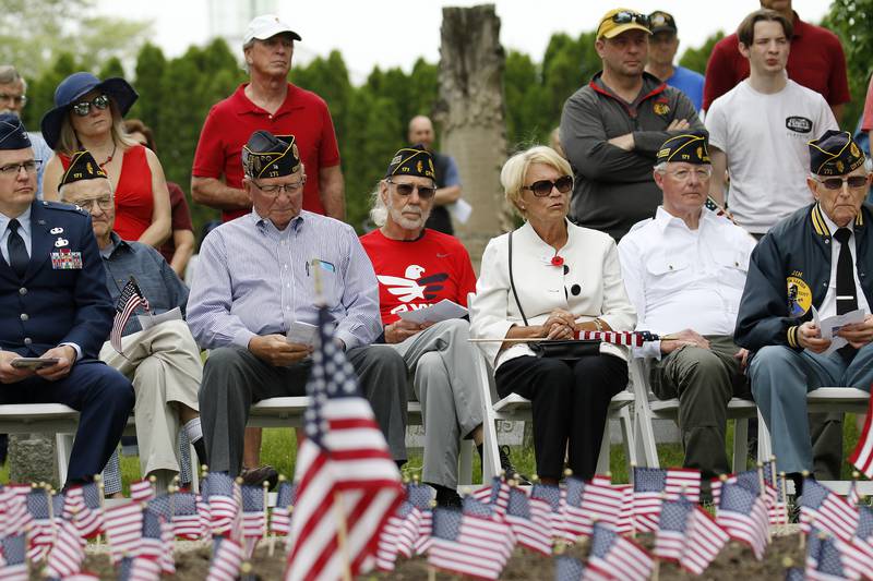 Attendees listen to the Memorial Day ceremony on Monday, May 31, 2021, in Crystal Lake. The parade began at Crystal Lake Central High School and continued through downtown, ending at Union Cemetery with a ceremony.