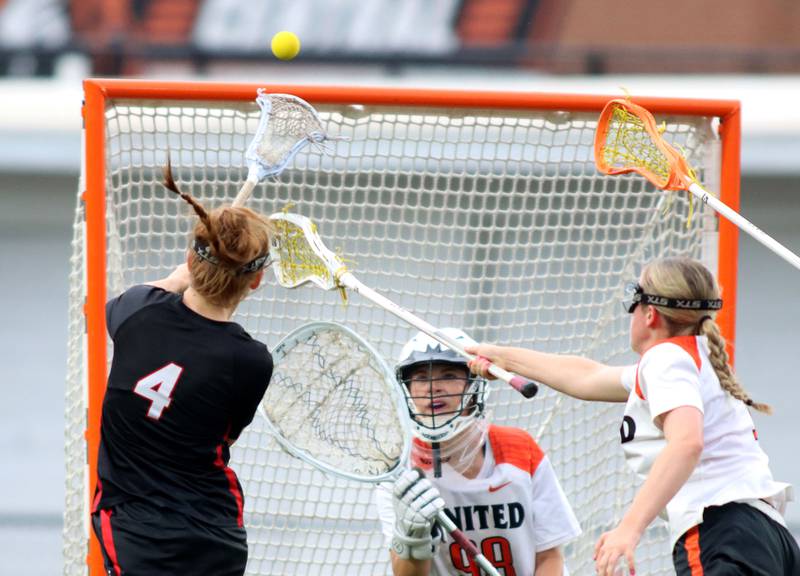 Crystal Lake Central United’s goalkeeper Anya Korczak, center, keeps an eye on the ball as Huntley’s Mya Holmberg, left, scores in IHSA Sectional Title Game action at Crystal Lake Central High School in Crystal Lake on Friday, May 30, 2025.