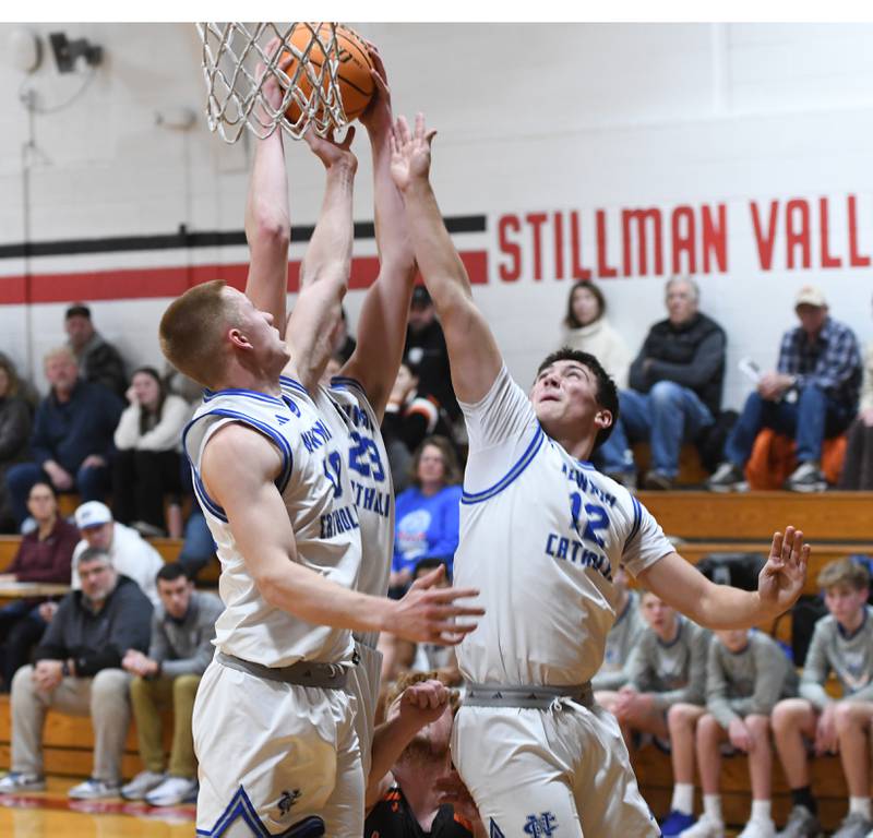 Sterling Newman's George Jungerman (10), John Rowzee (23) and Evan Bushman (12) rebound against Milledgeville on Saturday, Dec. 13, 2025 at the 64th Annual Forreston Holiday Basketball Tournament at Forreston High School.
