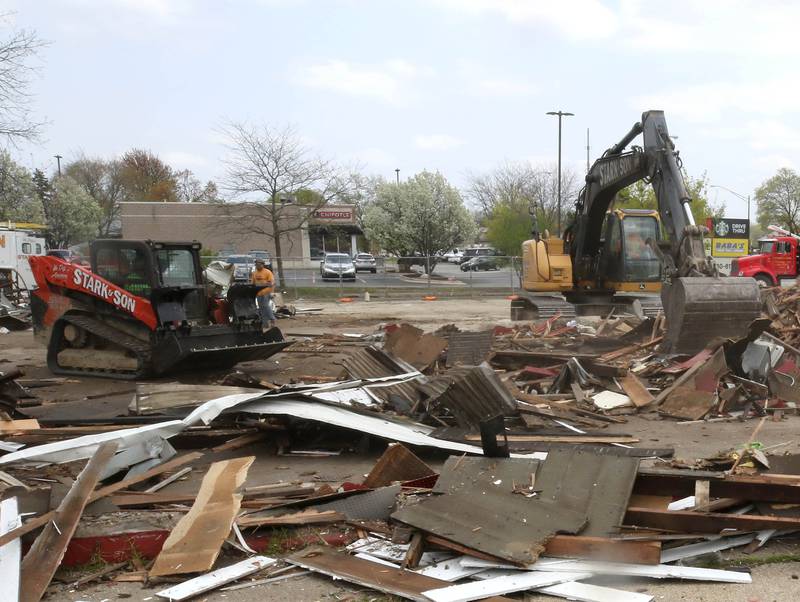 Workers from Stark & Son clean up debris Monday, April 28, 2025, after the former Illini Tire Co. building on the northeast corner West Lincoln Highway and Annie Glidden Road was torn down.