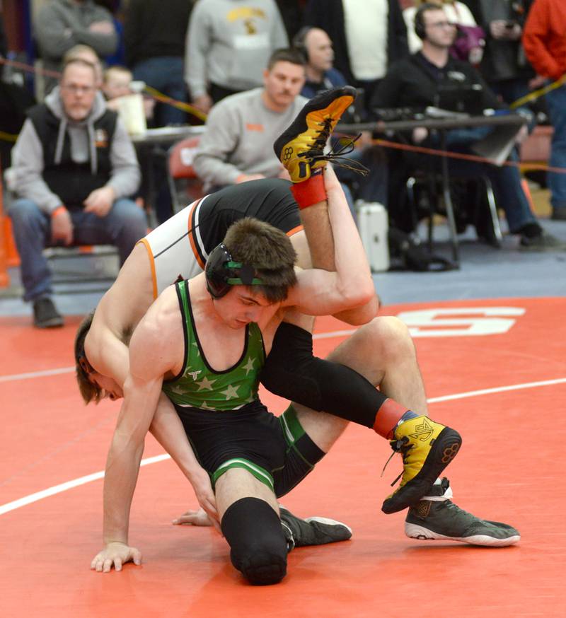 Sandwich’s Jaxson Blanchard gets flipped by Rock Falls’ Logan Williamson as they wrestle at 138 pounds at the 1A Oregon Sectional on Friday, Feb. 14, 2025.